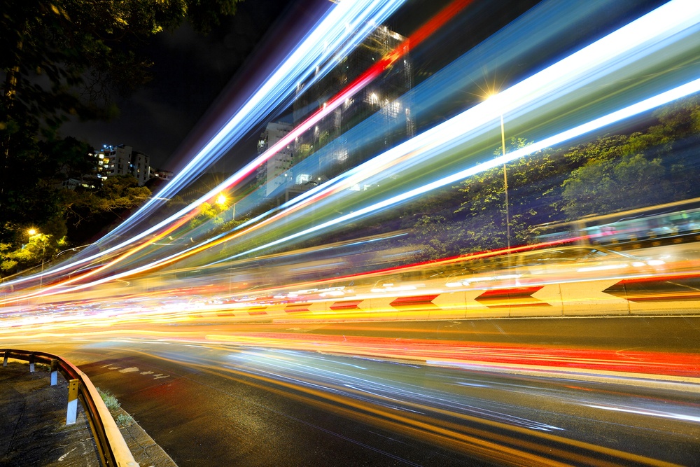 Fast moving car light on road at night